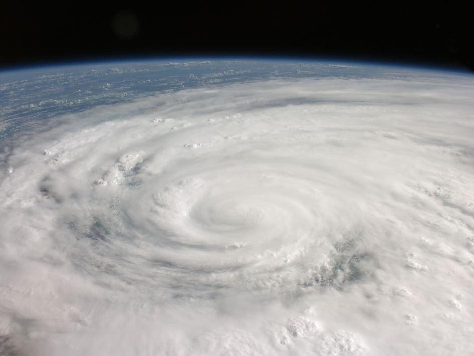 A hurricane, eye visible and clouds swirling, is seen from space—demonstrating global risk clarity via proven observation.