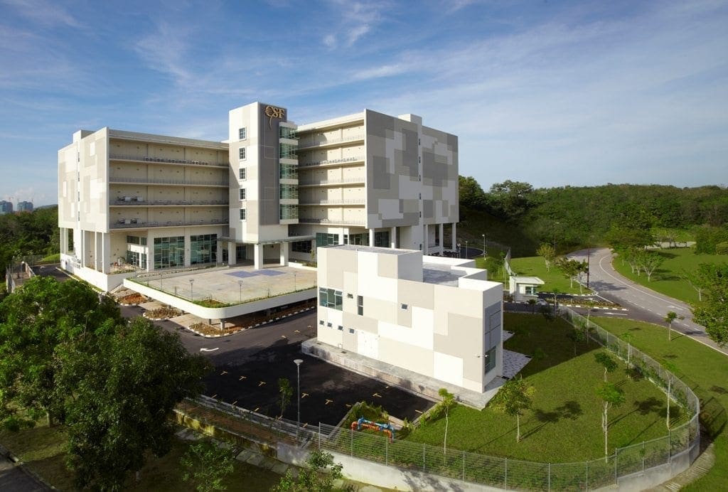 A modern building with white and gray facade amid lawns and trees illustrates why independent cyber risk due diligence matters today.