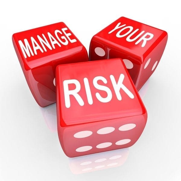 Three red dice with white lettering read MANAGE YOUR RISK, positioned on a white background—underscoring measured risk controls.